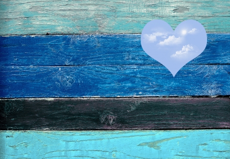 blue sky hole in a wooden wall backgroundの写真素材