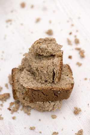 whole grain  buckwheat bread on white wooden background, homemade bread healthy food concept