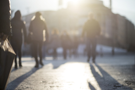 blur abstract people background, unrecognizable silhouettes of people walking on a streetの写真素材