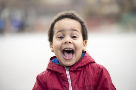 portrait of a beautiful multi racial boy with a huge smileの写真素材