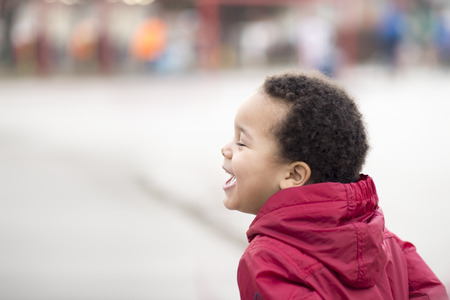 Portrait of a beautiful multi racial happy boy laughingの写真素材