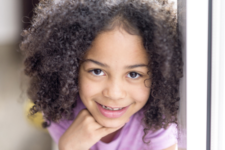 happy girl portrait, child smiling with tears in eyes, happy african american childの写真素材