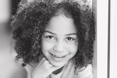 happy girl portrait, child smiling with tears in eyes, happy african american childの写真素材