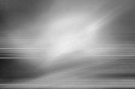 digitally generated image of white light and stripes moving fast over black backgroundの写真素材