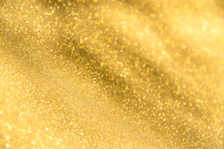 abstract defocused lights, sparkling holiday bokeh background with golden tones, elegant christmas backdropの写真素材