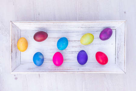 colorful Easter eggs on white wooden backgroundの写真素材
