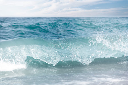 Waves breaking on the shore of the Mediterranean Sea. Selective focus.の写真素材