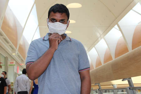 young asian man holding his maskの写真素材