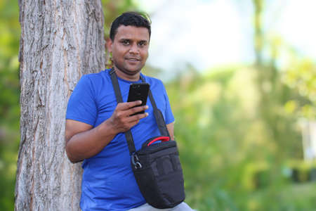 young man standing with a tree park outdoor