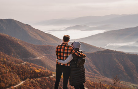 A happy couple who hikers enjoys a break look at the top of the mountain adventure travel.の写真素材