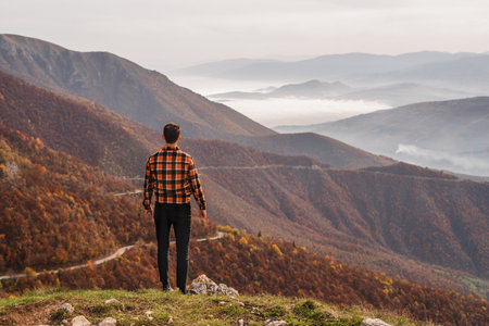 A man traveler enjoys a break look at the top of the mountain.の写真素材