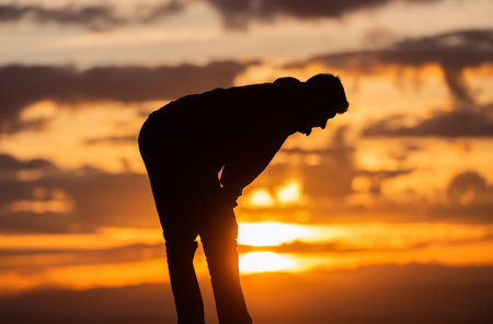 A Muslim prayer man praying at sunset.の写真素材