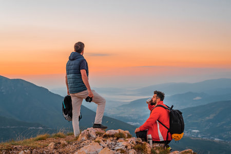 Two friends travelers enjoys a break look at the top of the mountain during the hike adventure travel.の写真素材