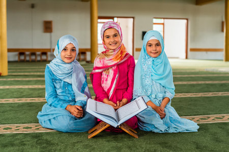 Group of a Muslim children reading a Quran inside the mosque.