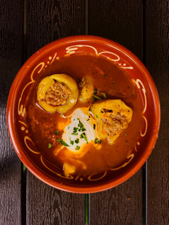 Top view baked stuffed pepper ( paprika ) with rice, meat and sour cream, a traditional dish.の写真素材