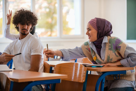 In the classroom group of diverse college students engages in discussion and knowledge exchange.