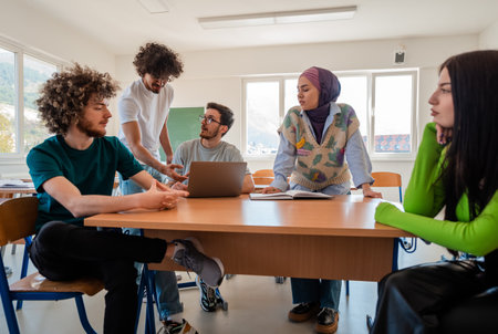 A group of diverse college students studying together or a business team working together on a...