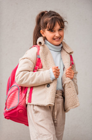 Portrait of a happy teenage female student isolated on wall background.の写真素材
