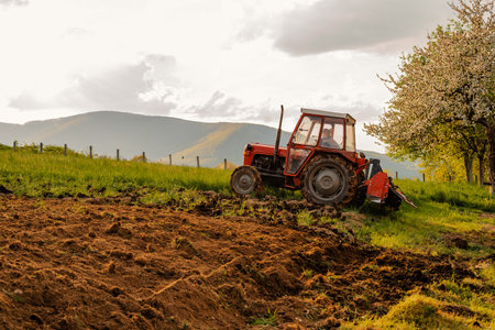 Tractor sowing crops at agricultural fields in spring.の写真素材