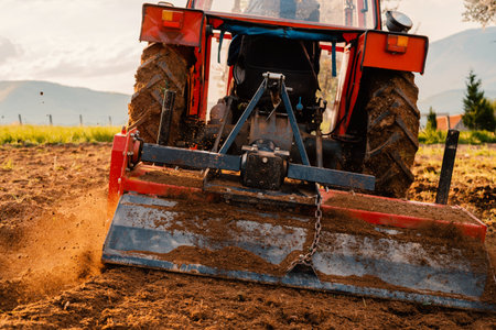 Tractor sowing crops at agricultural fields in spring.の写真素材