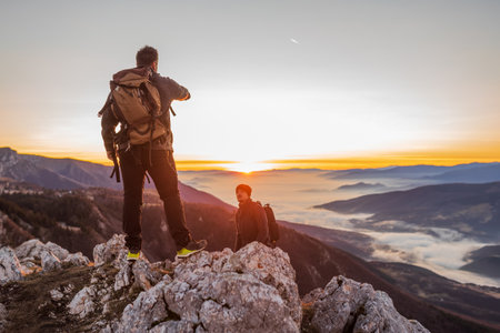 Two friends hikers hiking together on the mountain top adventure travel.