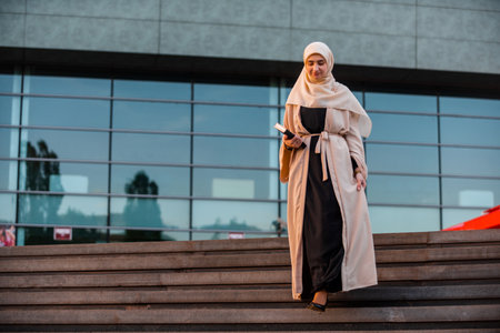 A successful Muslim business woman in hijab near the office building.の写真素材