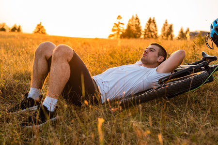 Mountain bike cyclist resting after trail forest rides healthy lifestyle.の写真素材