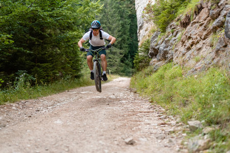 Professional mountain bike cyclist downhill trail riding action extreme sport outdoor.の写真素材