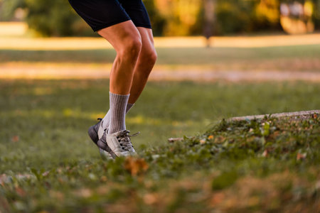 Sporty running man in cross country trail run.