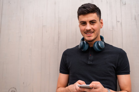 A young happy man using a phone mobile isolated on the background.