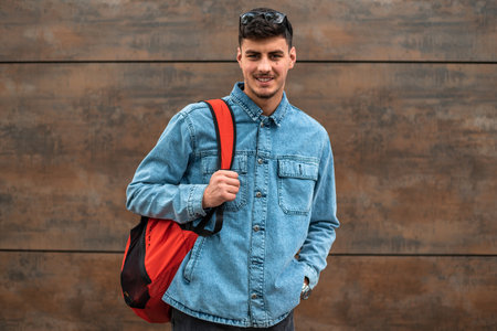 Portrait of a happy male college student isolated on background.