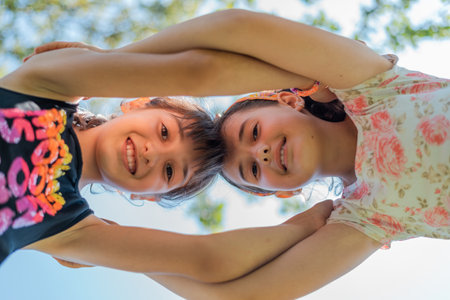 Close up face of happy children embracing each other and smiling at camera, concept of kids support, union.の写真素材