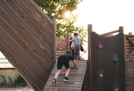 Children are playing in the summer park playground.