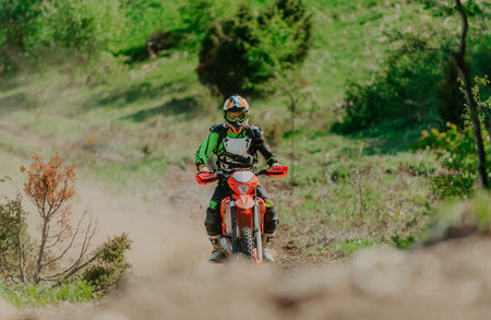 Professional enduro bike rider dirt ride on the muddy track. Motocross sport.の写真素材