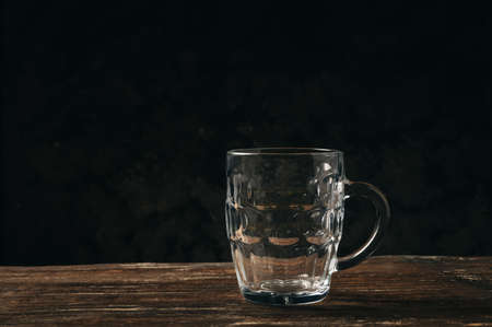 Empty beer glass mug on a wooden table.の写真素材