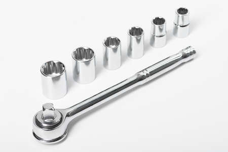 Chrome spanner with ratchet and set of heads, on a white isolated background.の写真素材
