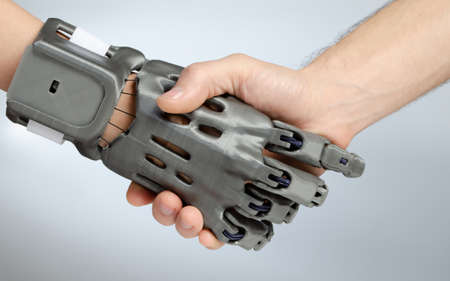 Hand with prosthesis printed on FDM 3D printer, handshake of the prosthesis and a healthy hand on an isolated background.の写真素材
