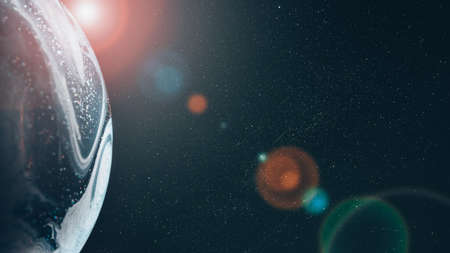 A planet in the rays of a star on the background of the starry sky. The concept of studying deep space for the presence of exoplanets suitable for life.の写真素材