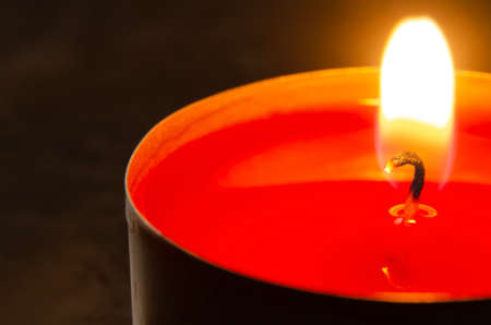 CHRISTMAS candle or romantic candle or funeral candle. Very close with a shallow depth of field. Wick candles close-up.の写真素材