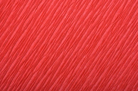 Background of red pressed corrugated paper with a diagonal texture taken close up
