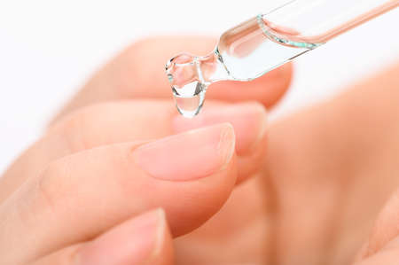 pipette with a drop of anti-brittle nails close-upの写真素材