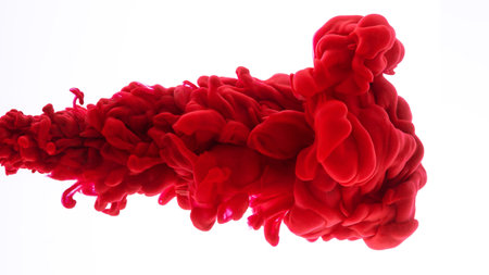 Red acrylic ink in water on white isolated background frozen motion very close up. Abstract background, color explosionの写真素材