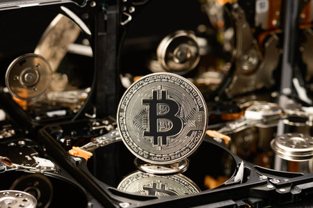 Bitcoin on the background of hard drives, the concept of mining cryptocurrencies using hard and SSD drives.の写真素材