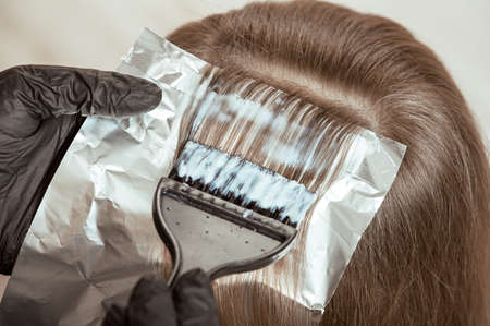 The process of coloring a lock of hair close-upの写真素材