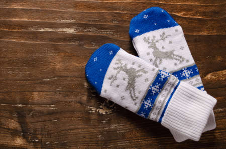 Warm mittens on a vintage wooden background.の写真素材