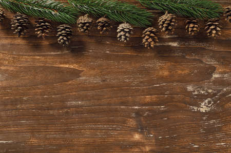 Fir branch and cones on vintage wooden backgroundの写真素材