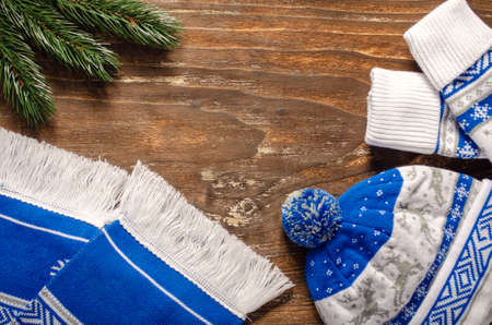 Warm mittens, scarf and hat on a vintage wooden background.の写真素材