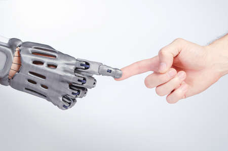 A hand with a prosthesis touches the finger of a finger of a healthy hand.の写真素材