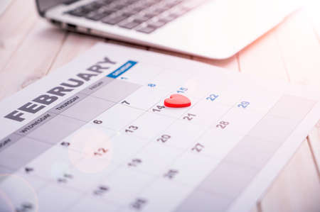 February 14, 2020 is the day of all lovers, the date is marked on the calendar with a heart symbol. Daylight with sun flare.の写真素材