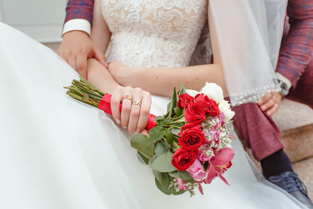 wedding rings of the bride and groom on their handsの写真素材